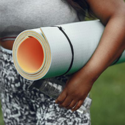 Close-up of a yoga mat and a water bottle in a calm setting.