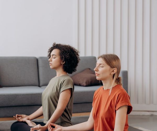 Woman in a focused yoga pose in a minimalist, clean room.